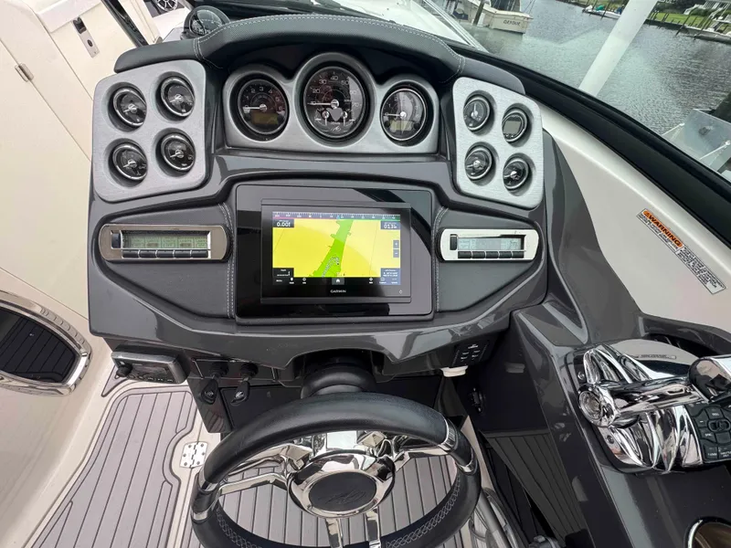 Slide: The Image of Dashboard of a 2013 Monterey 328 Super Sport boat with navigation display. - 23