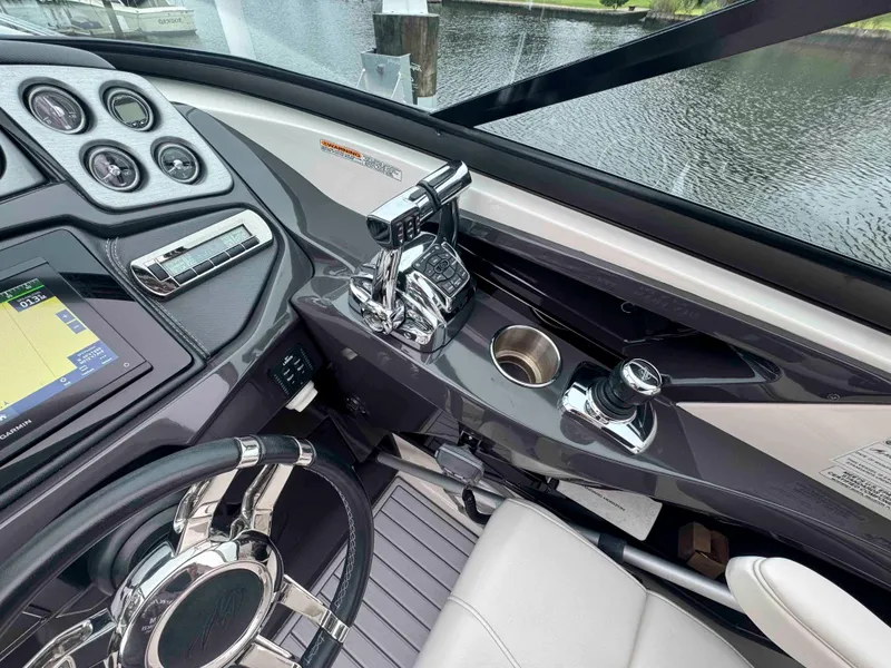 Slide: The Image of Cockpit of 2013 Monterey 328 Super Sport boat with steering wheel and control panel. - 24