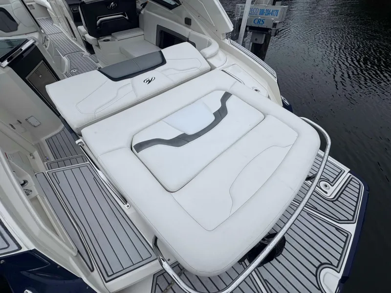 Slide: The Image of 2013 Monterey 328 Super Sport boat interior with white seating and sleek design. - 26
