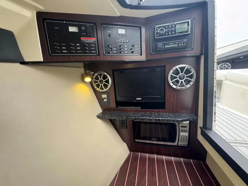 Slide: The Image of Interior of 2013 Monterey 328 Super Sport with control panel, speakers, TV, and microwave. - 28