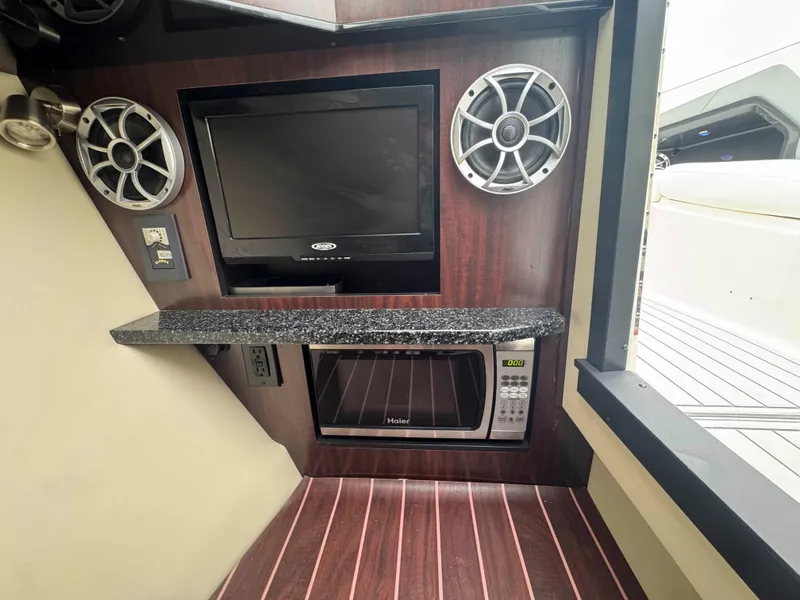 Slide: The Image of Interior of 2013 Monterey 328 Super Sport with TV, speakers, and microwave. - 31