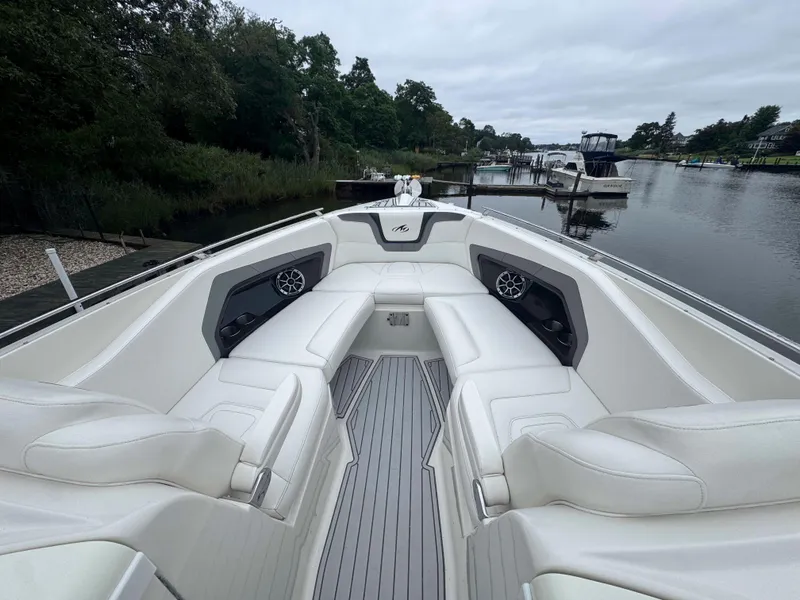 Slide: The Image of 2013 Monterey 328 Super Sport boat with white seating, docked on a calm river. - 35