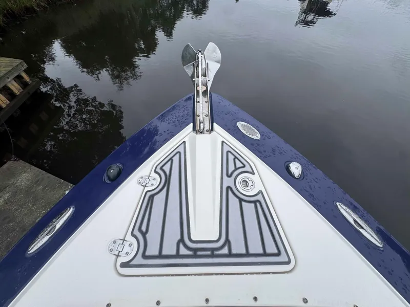 Slide: The Image of Bow of 2013 Monterey 328 Super Sport boat with anchor, docked on calm water. - 38