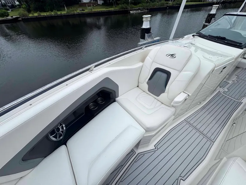 Slide: The Image of 2013 Monterey 328 Super Sport boat interior with white seating and cup holders. - 39