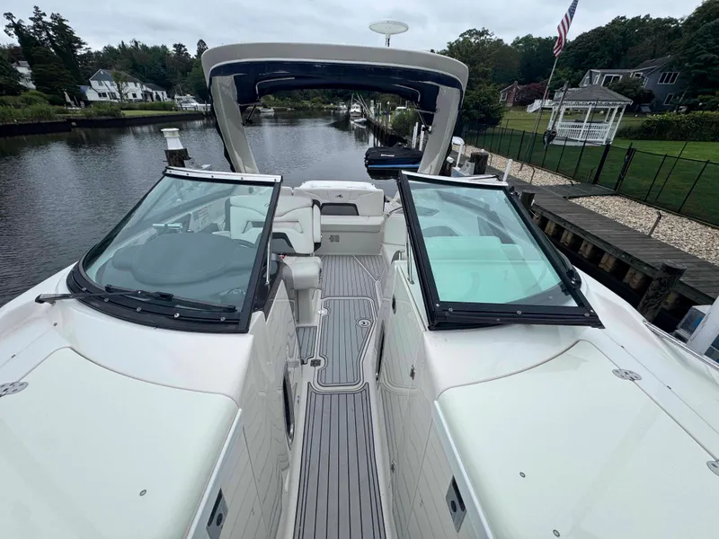 Slide: The Image of 2013 Monterey 328 Super Sport boat docked on a serene waterfront. - 41