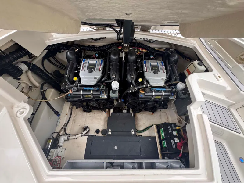 Slide: The Image of Engine compartment of a 2013 Monterey 328 Super Sport boat, showcasing dual engines. - 46