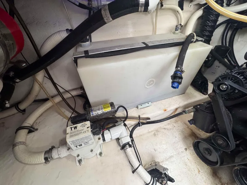 Slide: The Image of Engine compartment of a 2013 Monterey 328 Super Sport boat, showing hoses and mechanical components. - 49