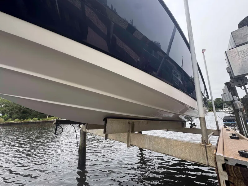 Slide: The Image of 2013 Monterey 328 Super Sport boat on lift by waterfront. - 5