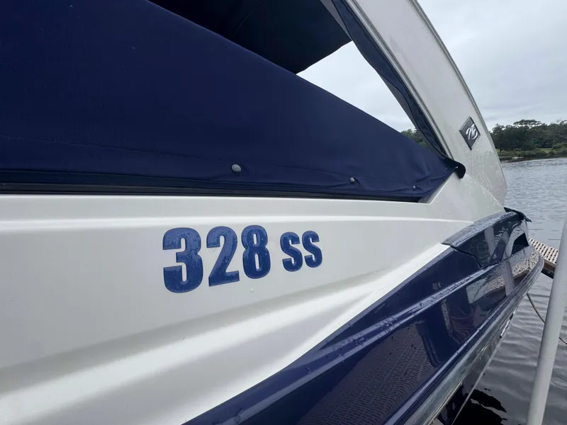 Slide: The Image of 2013 Monterey 328 Super Sport boat docked by the water. - 9