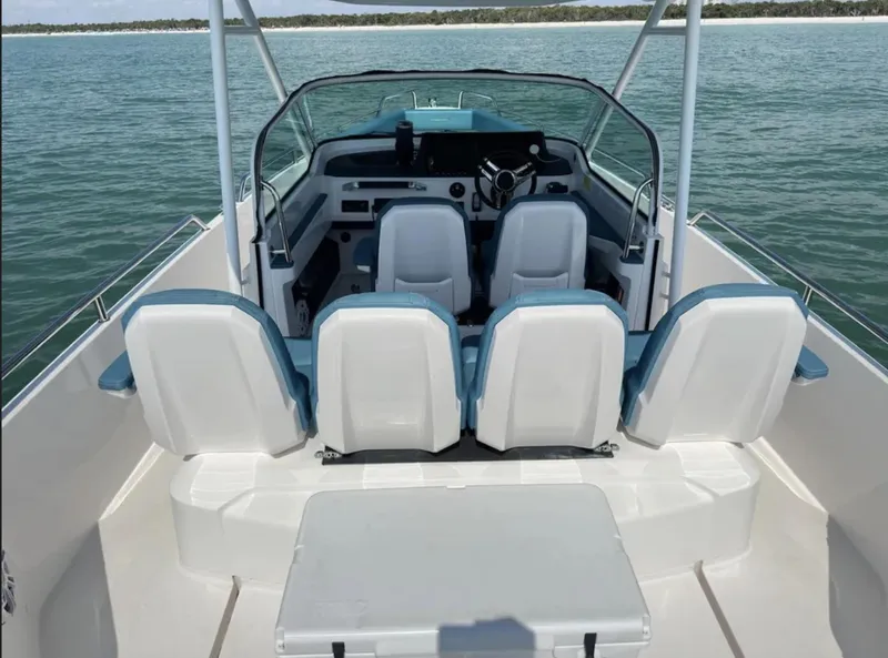 Slide: The Image of 2020 Axopar 28 TT boat interior with seating, on calm water. - 13