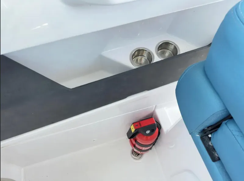 Slide: The Image of Interior of 2020 Axopar 28 TT boat with cup holders and fire extinguisher. - 14