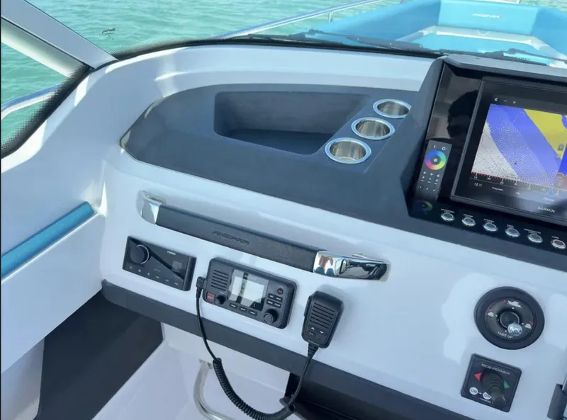 Slide: The Image of 2020 Axopar 28 TT boat dashboard with navigation system and controls. - 16