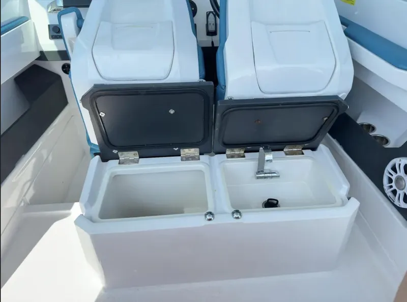 Slide: The Image of 2020 Axopar 28 TT boat interior with open storage compartments and sink. - 19