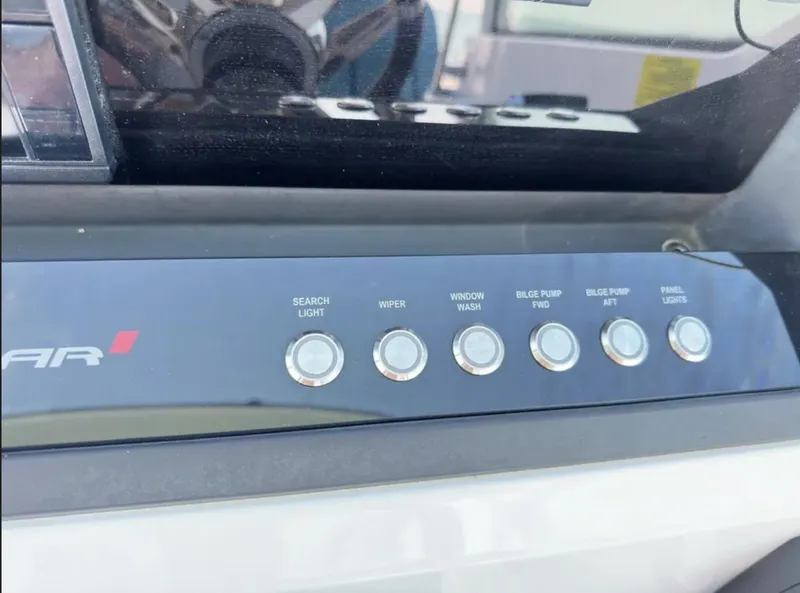 Slide: The Image of Control panel of a 2020 Axopar 28 TT boat with labeled buttons. - 22