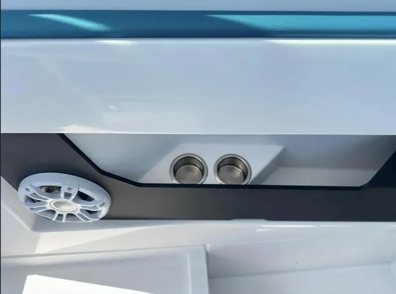 Slide: The Image of Interior detail of a 2020 Axopar 28 TT boat, featuring speaker and cup holders. - 24