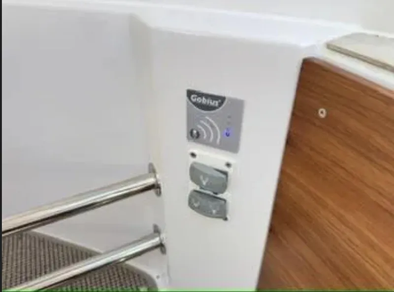 Slide: The Image of Control panel on 2020 Axopar 28 TT boat with wooden and metal accents. - 25