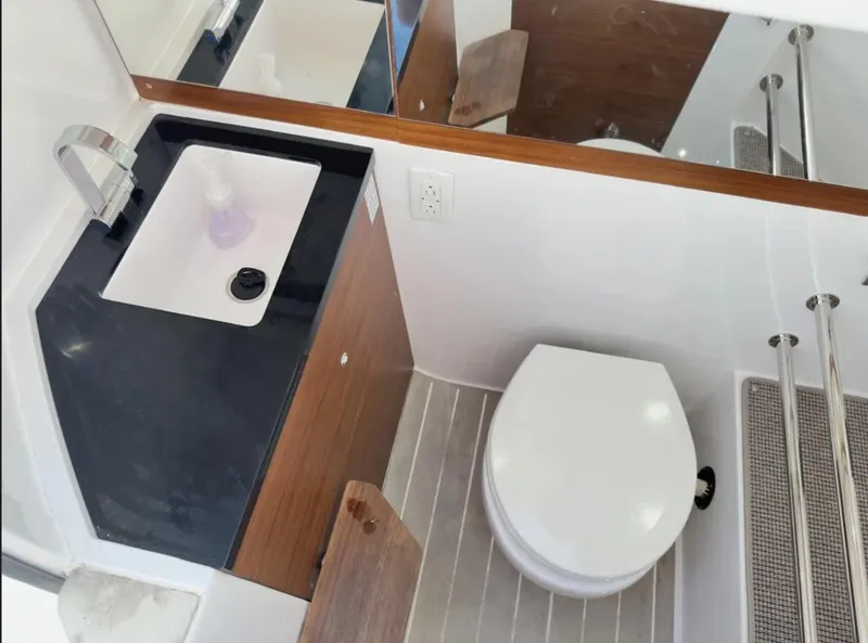 Slide: The Image of Compact bathroom in 2020 Axopar 28 TT boat with sink and toilet. - 27
