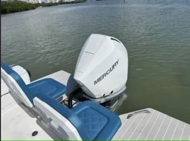 Slide: The Image of 2020 Axopar 28 TT boat with Mercury outboard engine on calm water. - 28