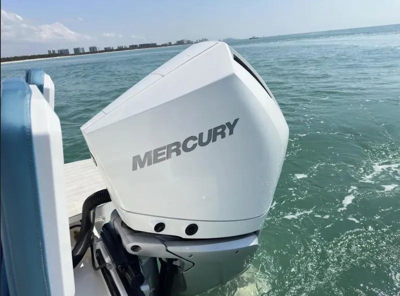 Slide: The Image of Outboard motor on 2020 Axopar 28 TT boat in ocean waters. - 29