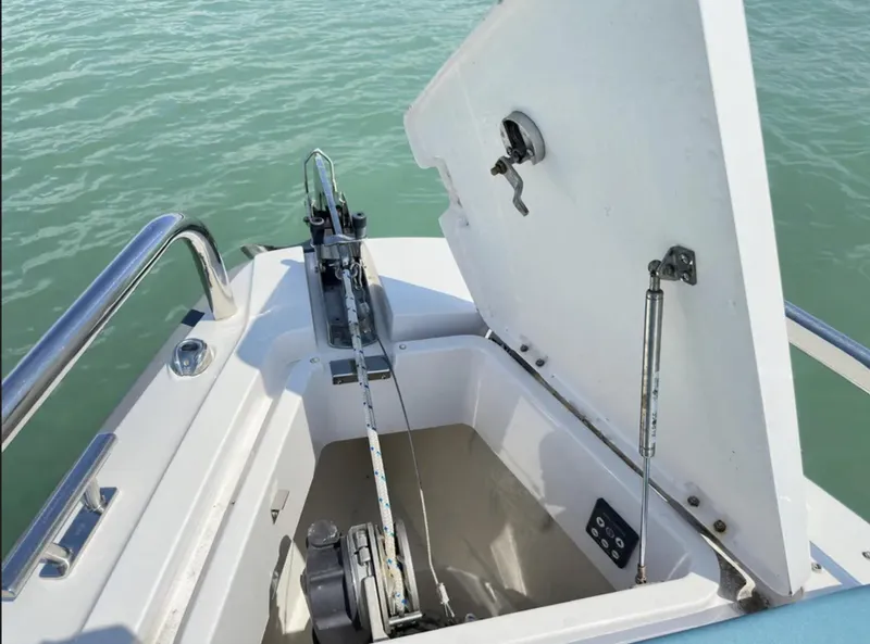 Slide: The Image of Open anchor compartment on 2020 Axopar 28 TT boat, showing winch and rope. - 3