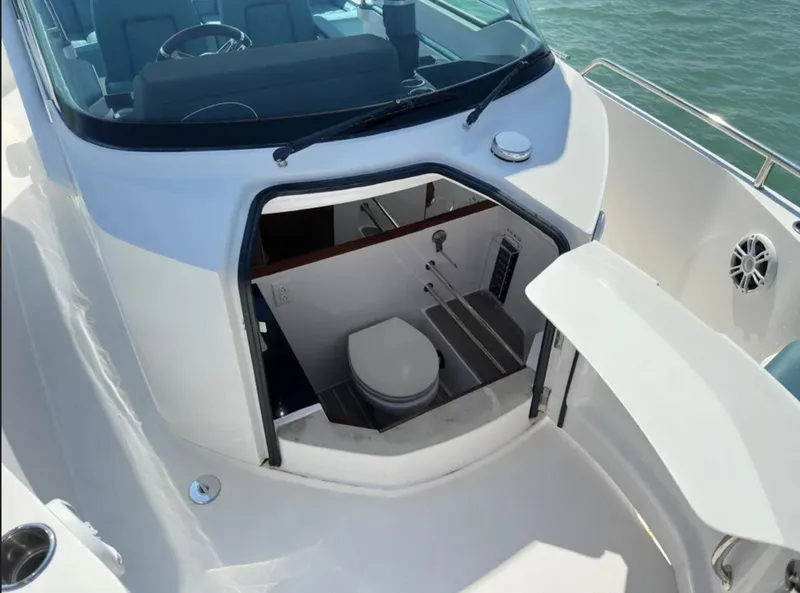 Slide: The Image of 2020 Axopar 28 TT boat with open cabin toilet, sleek white design. - 6