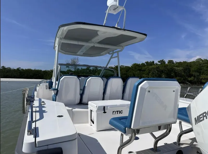 Slide: The Image of 2020 Axopar 28 TT boat with seating and RTIC cooler on deck. - 8