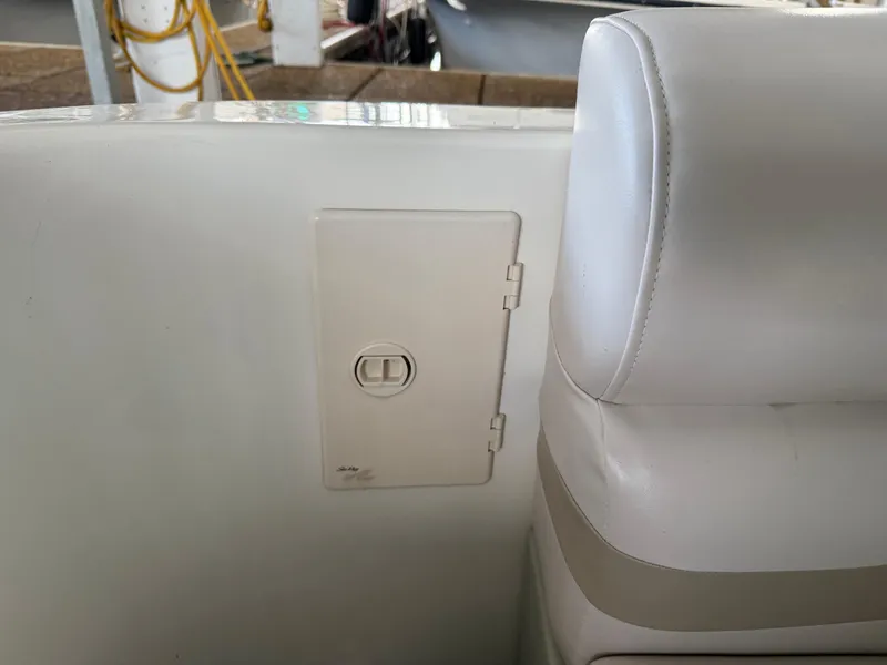 Slide: The Image of White interior of 1999 Sea Ray 400 Sedan Bridge with seat and access panel. - 12