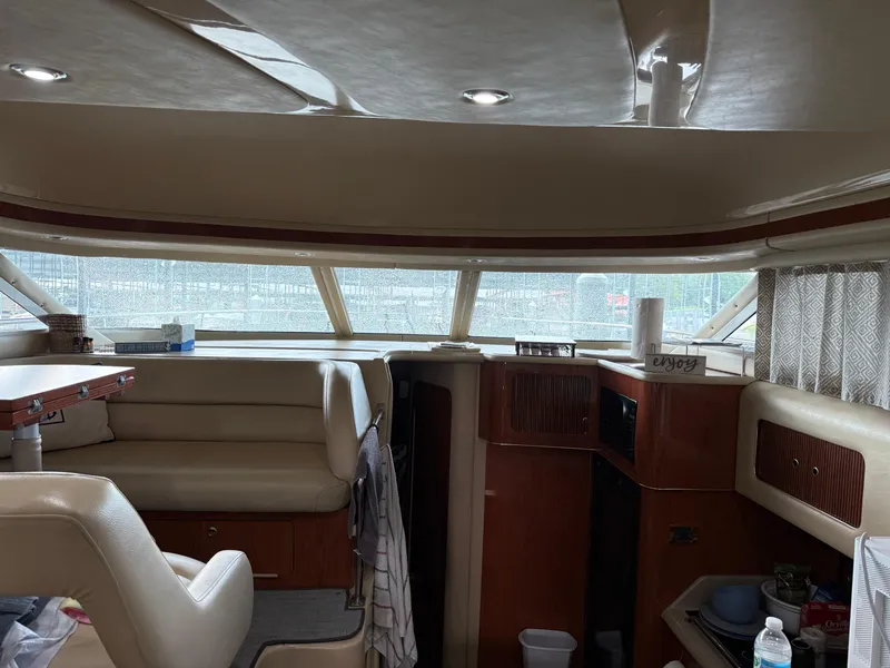 Slide: The Image of Interior of 1999 Sea Ray 400 Sedan Bridge yacht with seating and wooden cabinetry. - 13