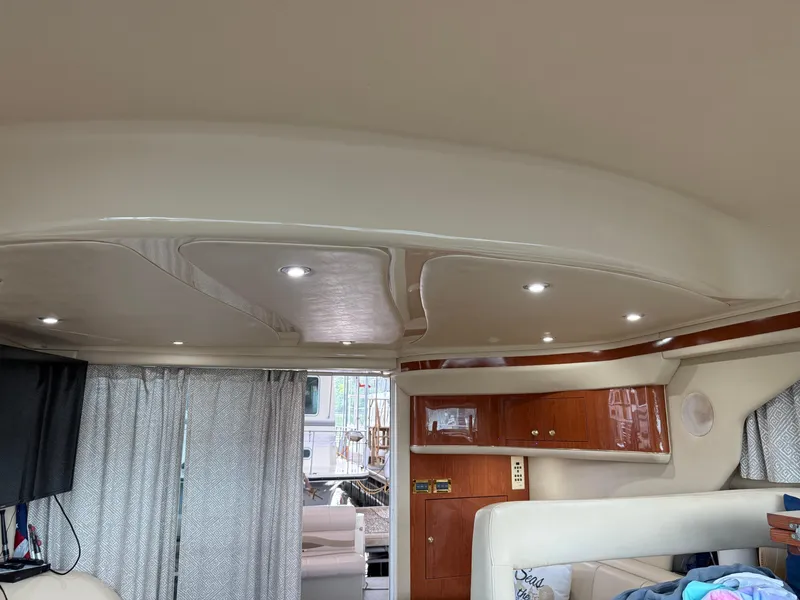 Slide: The Image of Interior of 1999 Sea Ray 400 Sedan Bridge with modern lighting and wood cabinetry. - 14