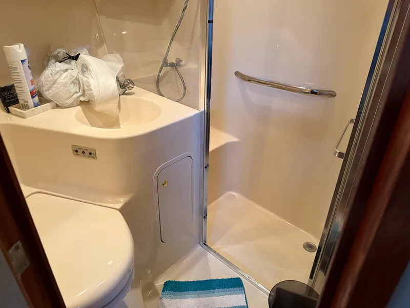 Slide: The Image of Bathroom interior of 1999 Sea Ray 400 Sedan Bridge yacht with shower and sink. - 17