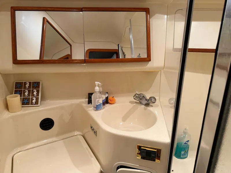 Slide: The Image of Bathroom interior of 1999 Sea Ray 400 Sedan Bridge yacht, featuring sink and mirror. - 22