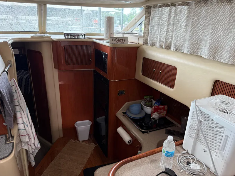 Slide: The Image of Interior of 1999 Sea Ray 400 Sedan Bridge yacht with kitchen amenities. - 28
