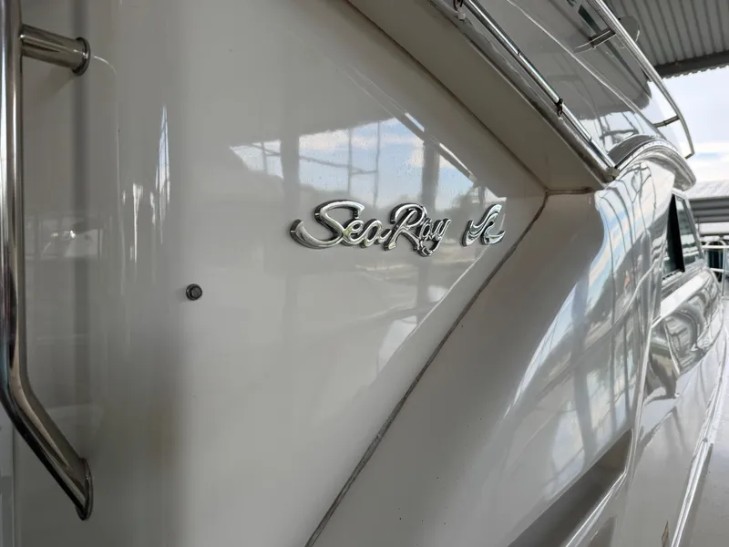 Slide: The Image of 1999 Sea Ray 400 Sedan Bridge yacht with chrome logo detail. - 3