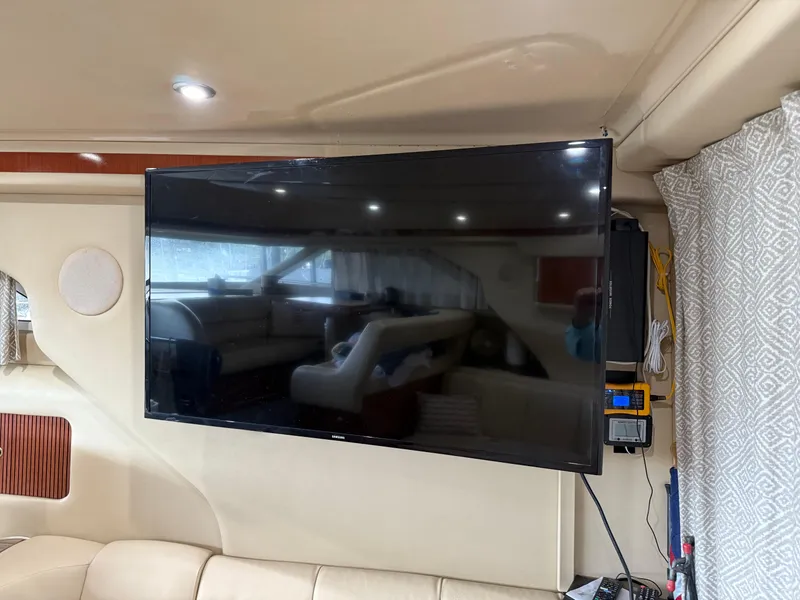 Slide: The Image of Interior of 1999 Sea Ray 400 Sedan Bridge with mounted flat-screen TV. - 31