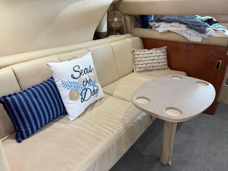 Slide: The Image of Interior of 1999 Sea Ray 400 Sedan Bridge with cozy seating and decorative pillows. - 32