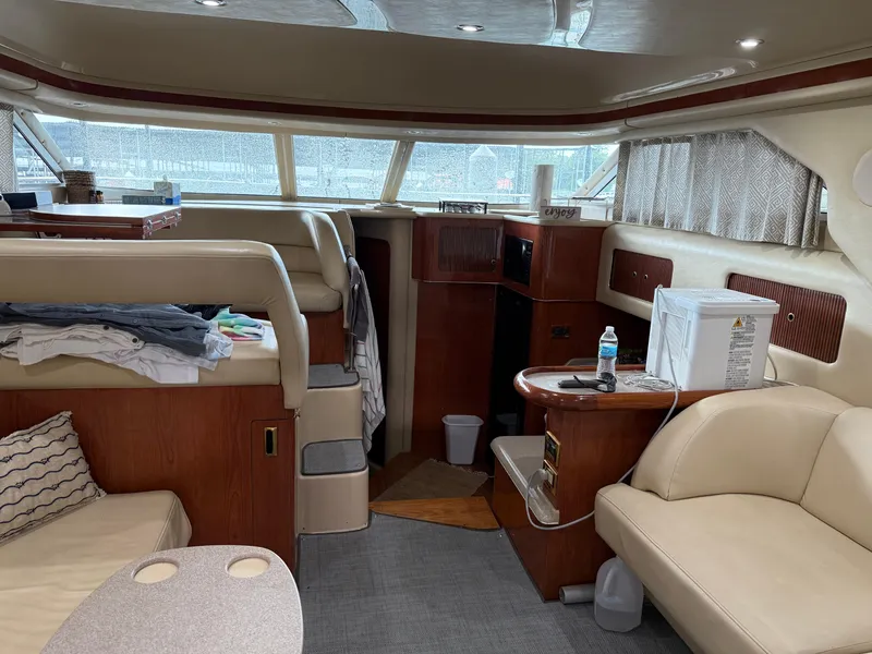 Slide: The Image of Interior of a 1999 Sea Ray 400 Sedan Bridge yacht with beige seating and wooden accents. - 34