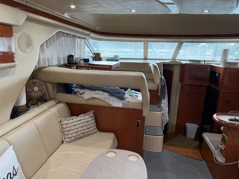 Slide: The Image of Interior of a 1999 Sea Ray 400 Sedan Bridge yacht with cozy seating and elegant wood finishes. - 35