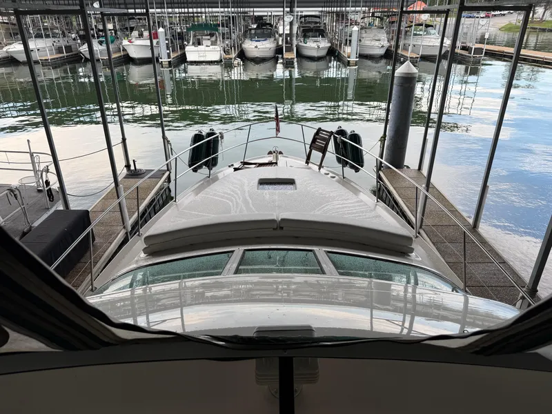 Slide: The Image of 1999 Sea Ray 400 Sedan Bridge docked in a marina with multiple boats. - 36