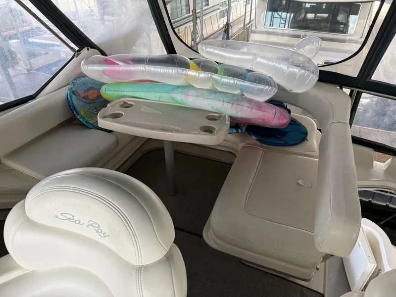 Slide: The Image of Interior of 1999 Sea Ray 400 Sedan Bridge with seating and inflatables. - 37