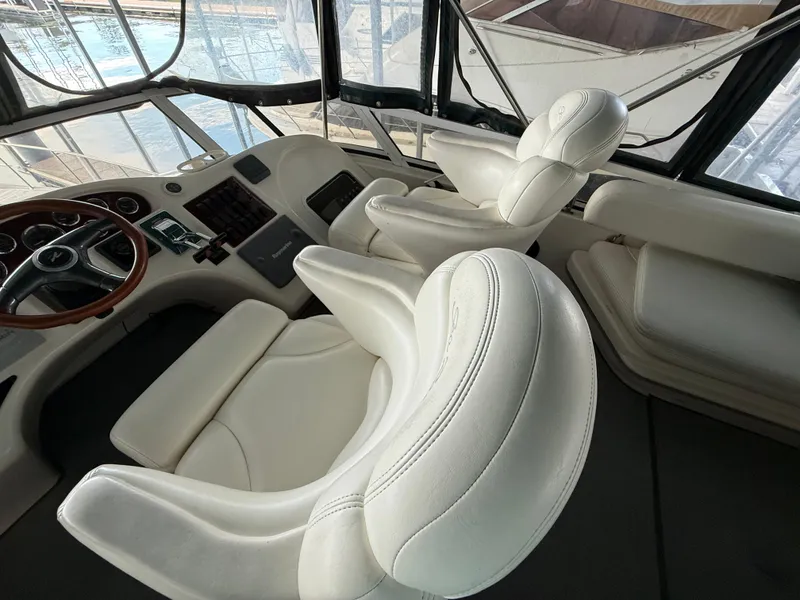 Slide: The Image of Luxurious interior of 1999 Sea Ray 400 Sedan Bridge with white leather seating. - 40