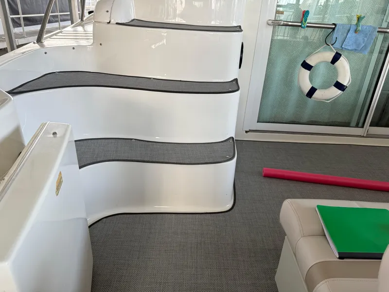 Slide: The Image of 1999 Sea Ray 400 Sedan Bridge interior with steps, life preserver, and seating area. - 45