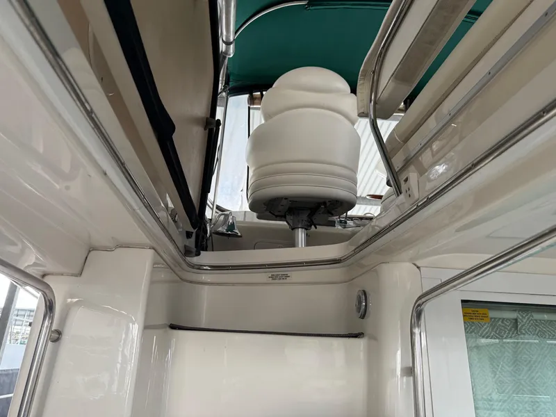 Slide: The Image of Interior view of a 1999 Sea Ray 400 Sedan Bridge yacht with white and green accents. - 46