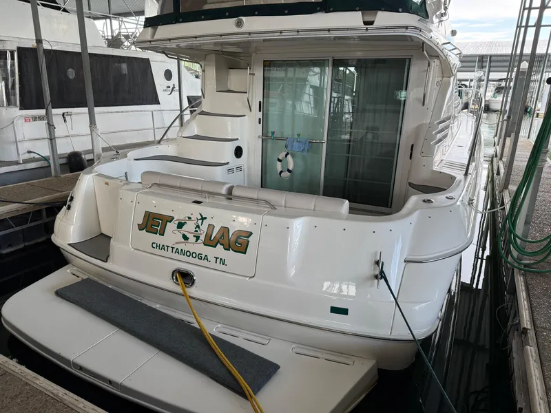 Slide: The Image of 1999 Sea Ray 400 Sedan Bridge docked, rear view with "Jet Lag" signage, Chattanooga, TN. - 5