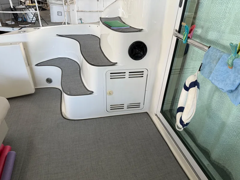 Slide: The Image of Interior view of 1999 Sea Ray 400 Sedan Bridge with steps and nautical decor. - 8