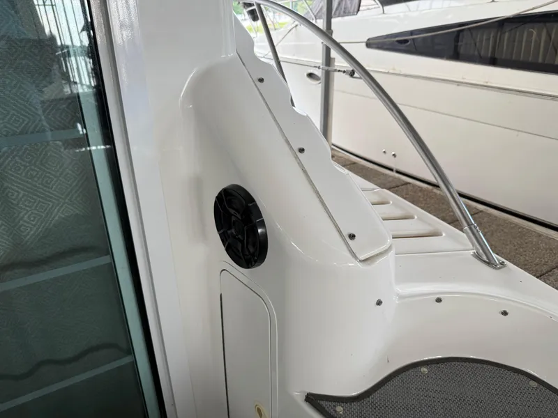 Slide: The Image of 1999 Sea Ray 400 Sedan Bridge boat interior with speaker and railing detail. - 9