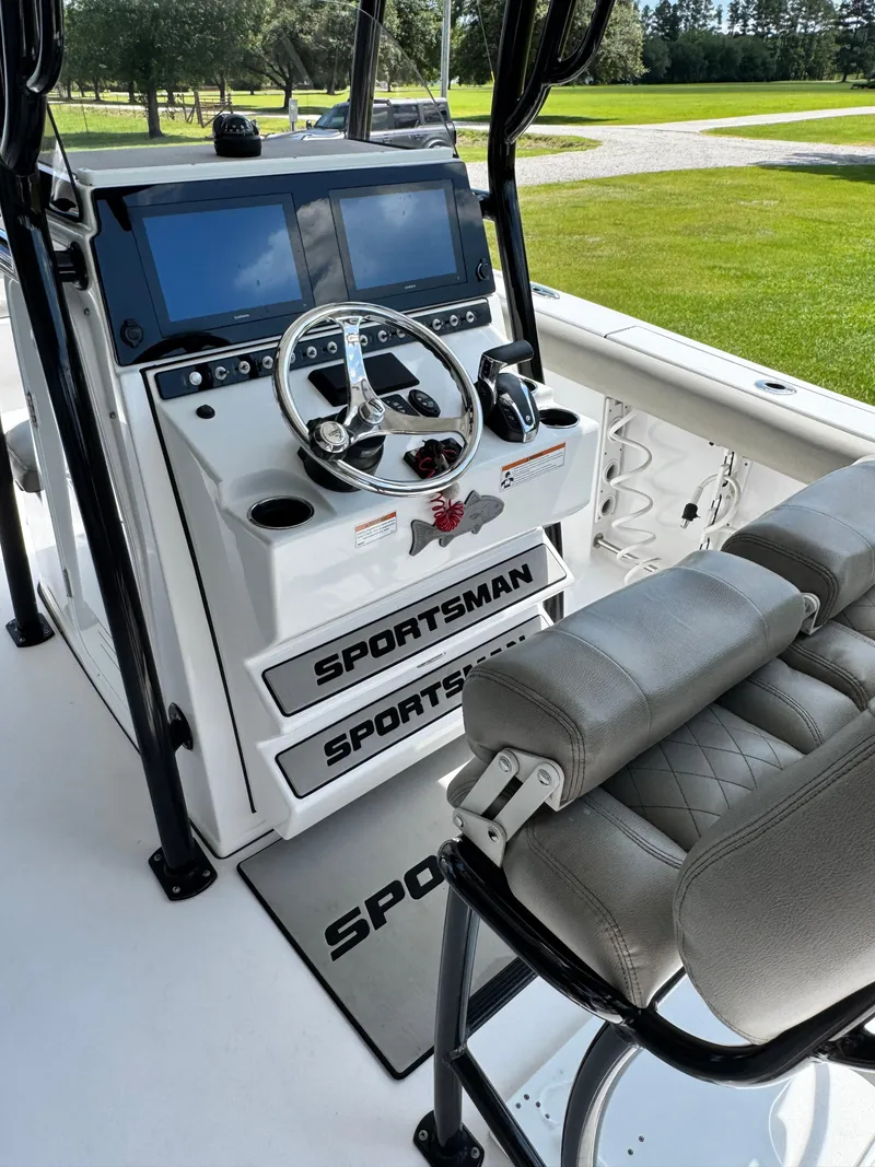 Slide: The Image of 2022 Sportsman Open 242 Center Console boat interior with dual screens and steering wheel. - 3