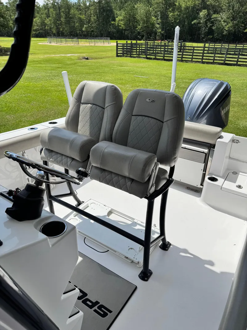 Slide: The Image of 2022 Sportsman Open 242 Center Console boat interior with dual seats and engine view. - 6