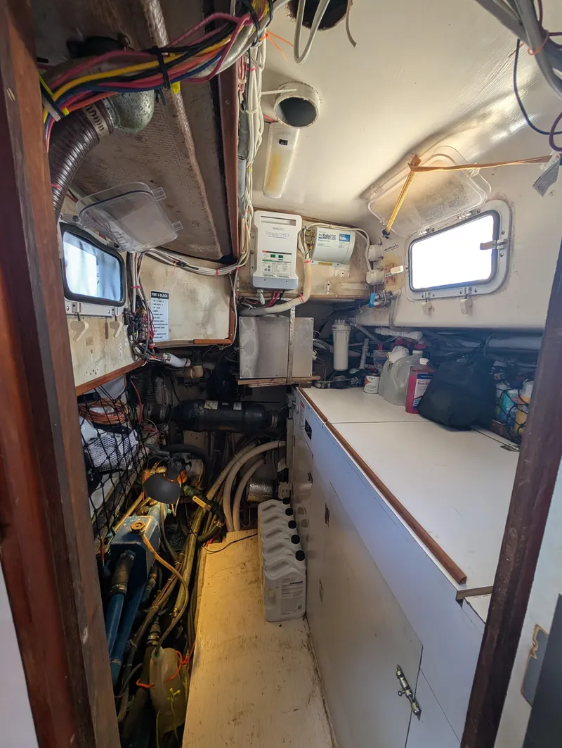 Slide: The Image of Engine room of a 1976 Mason COHORT II boat, featuring wiring and equipment. - 13