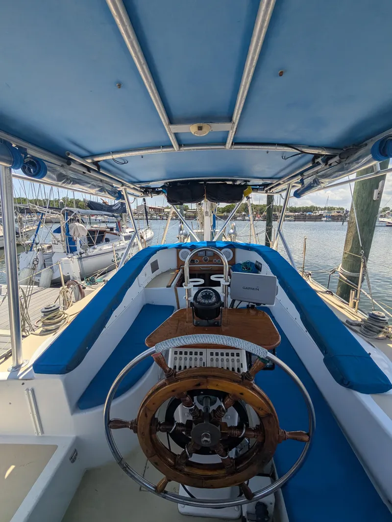 Slide: The Image of Cockpit of 1976 Mason COHORT II sailboat with blue canopy and wooden steering wheel. - 15
