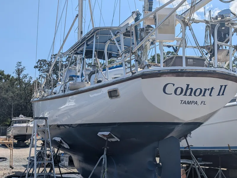Slide: The Image of Sailboat "Cohort II" from 1976, docked in Tampa, Florida, with clear blue skies. - 19